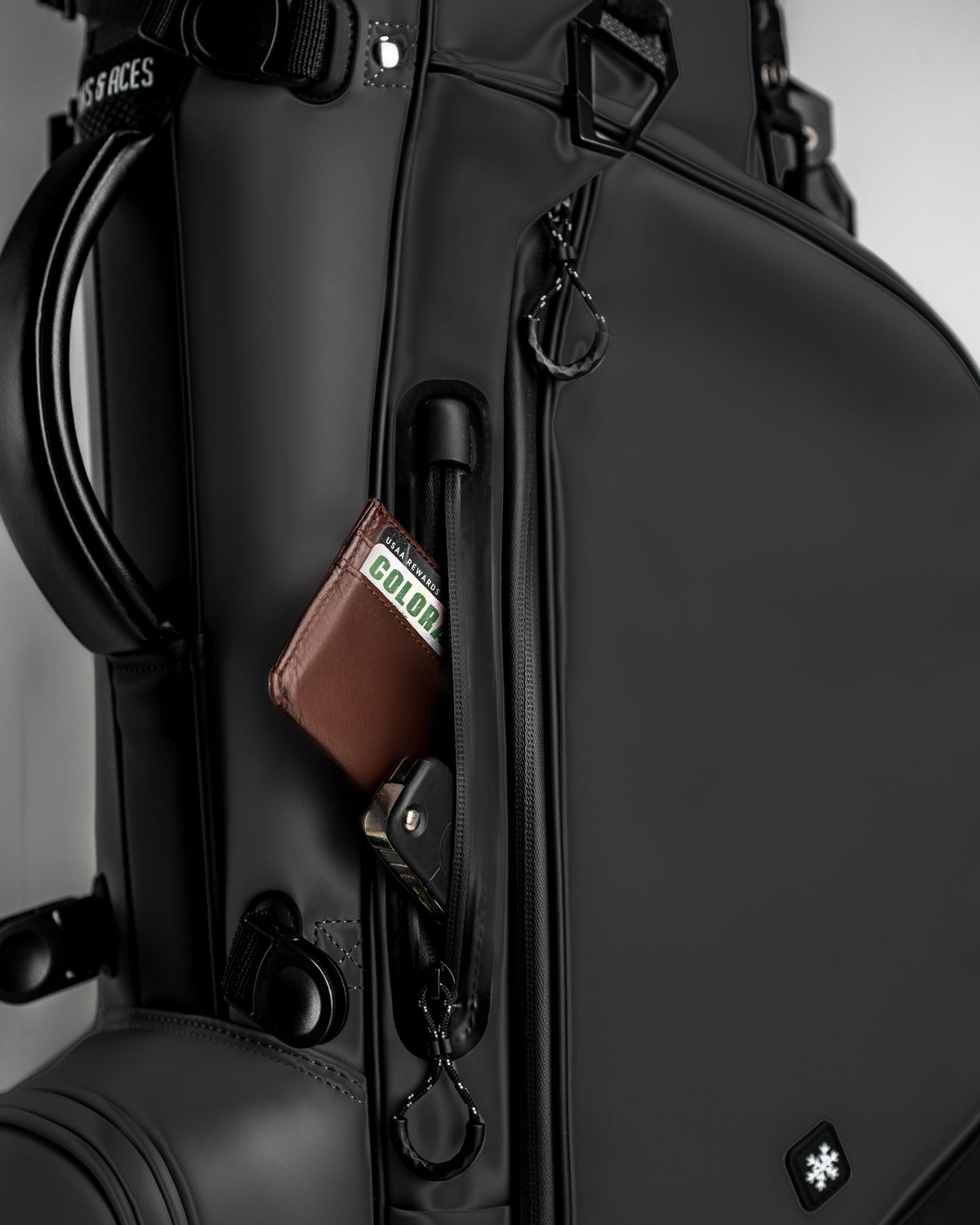 Sleek Player Preferred Golf Bag in Obsidian with a side pocket showcasing a wallet and keychain for convenient storage.