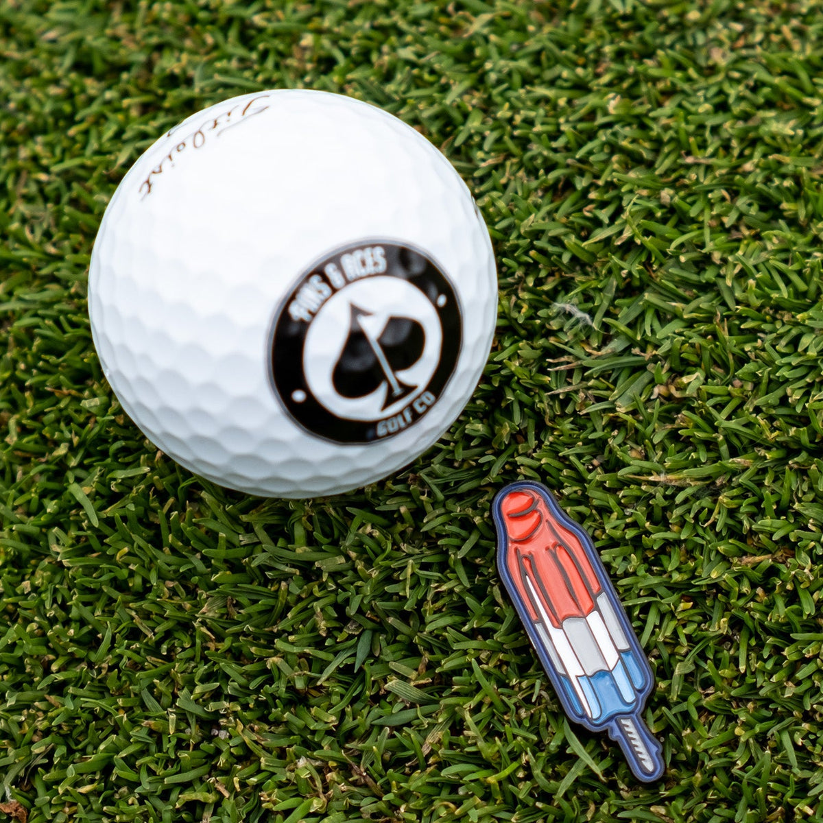 Popsicle-shaped ball marker featuring bright colors and a fun design, ideal for golf enthusiasts.