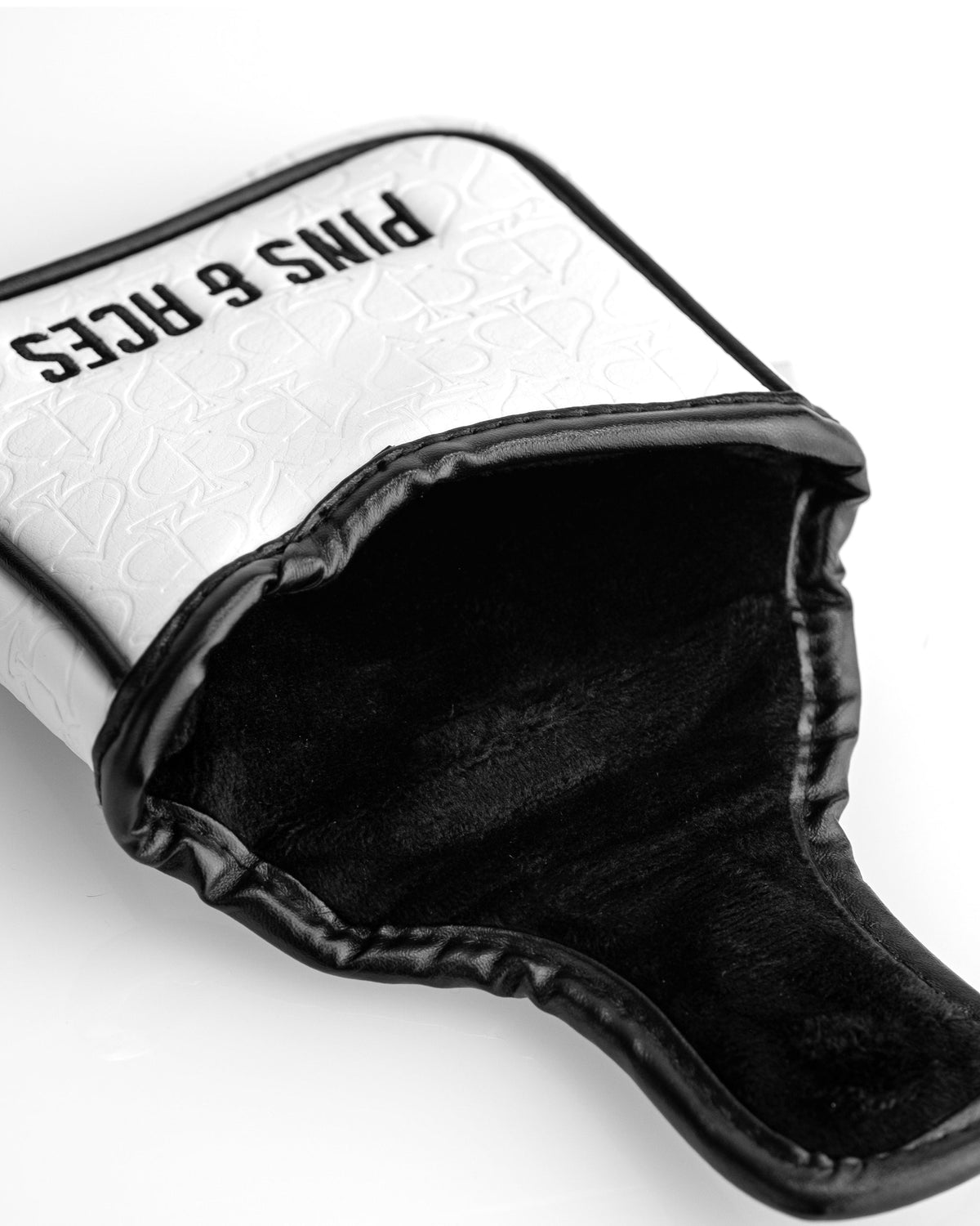 Black and white golf club headcover with bold "PINS & RICE" text, featuring a textured pattern and contrasting trim for bo...