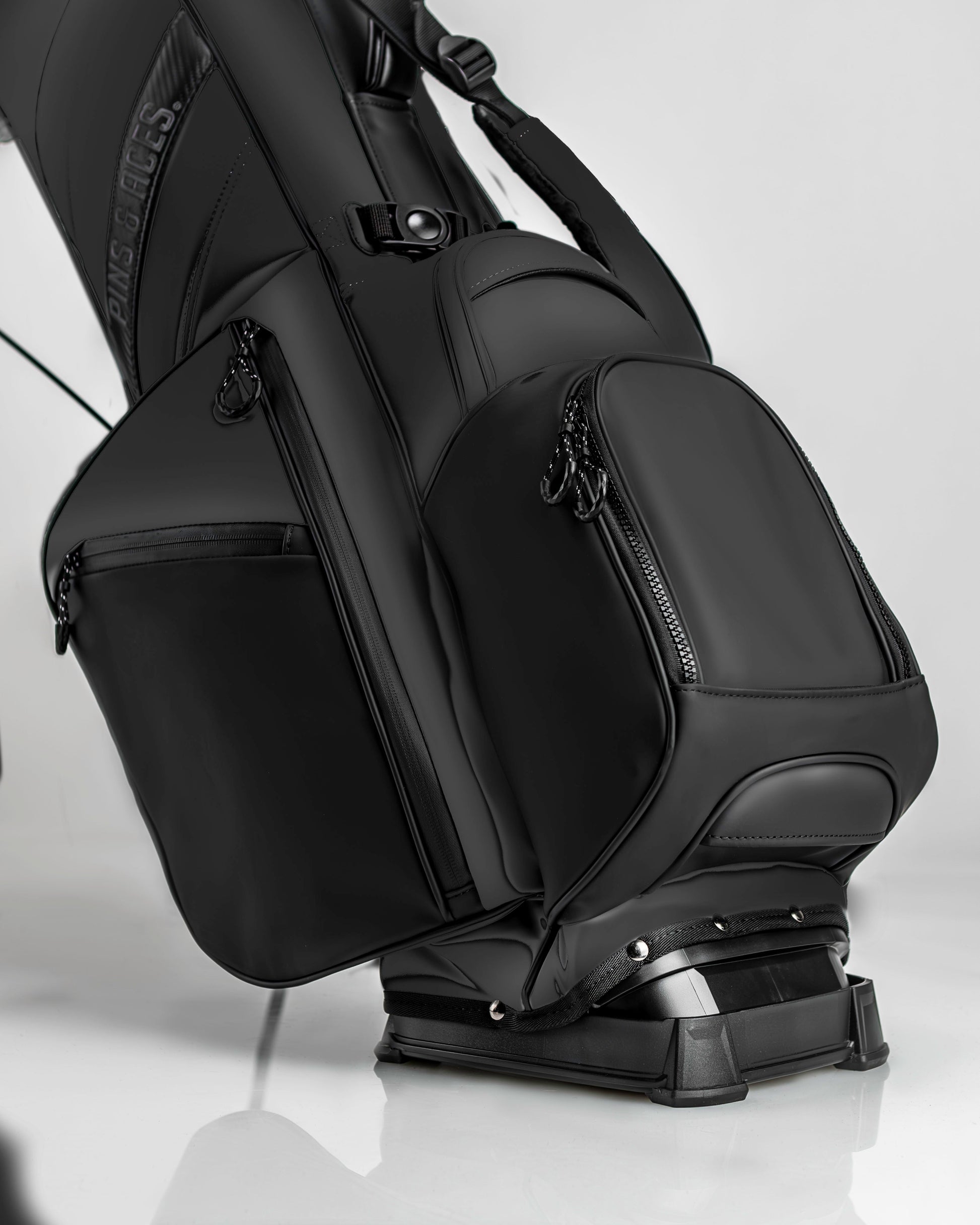 Sleek Player Preferred Golf Bag in Obsidian with multiple zippered pockets and a sturdy base for stability on the course.