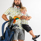 Father and son wearing matching TMNT Cowabunga Classic 8-Bit shirts, holding golf clubs and a bag, showcasing playful style.