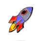 Rocket emoji ball marker with vibrant colors and cartoonish design, ideal for golf enthusiasts.