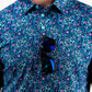 Brightly colored fluorescent floral dress with a vibrant pattern on a model, showcasing a spring/summer style.