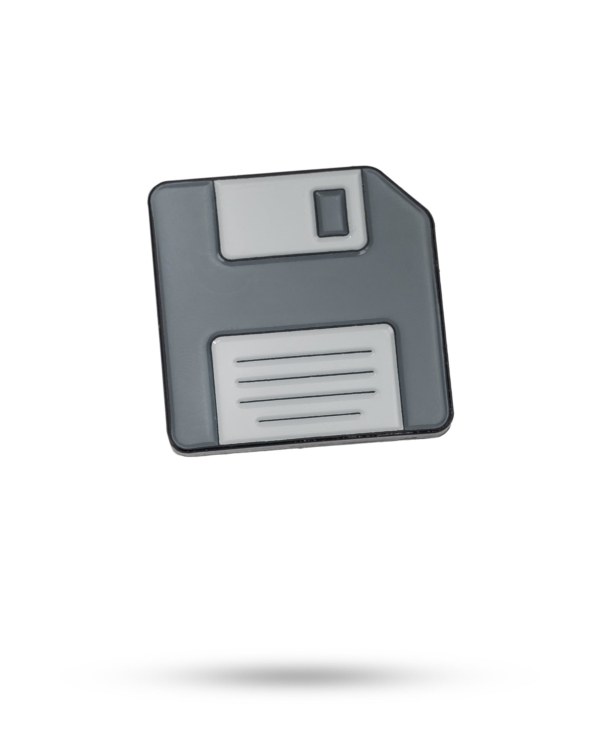 Floppy disc ball marker featuring a retro design, perfect for golfers.
