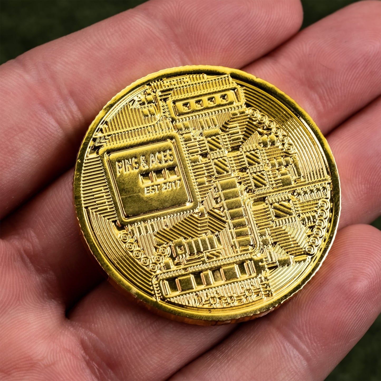 Bitcoin ball marker in hand, showcasing a metallic finish and intricate Bitcoin design.