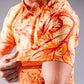 Men's Cabo Sunburst polo shirt in vibrant orange and yellow gradient design, featuring a classic collar and short sleeves.