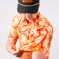Cabo Sunburst polo shirt in vibrant orange, featuring a classic collar and short sleeves.