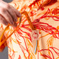 Cabo Sunburst polo shirt in vibrant yellow with a stylish design and short sleeves.