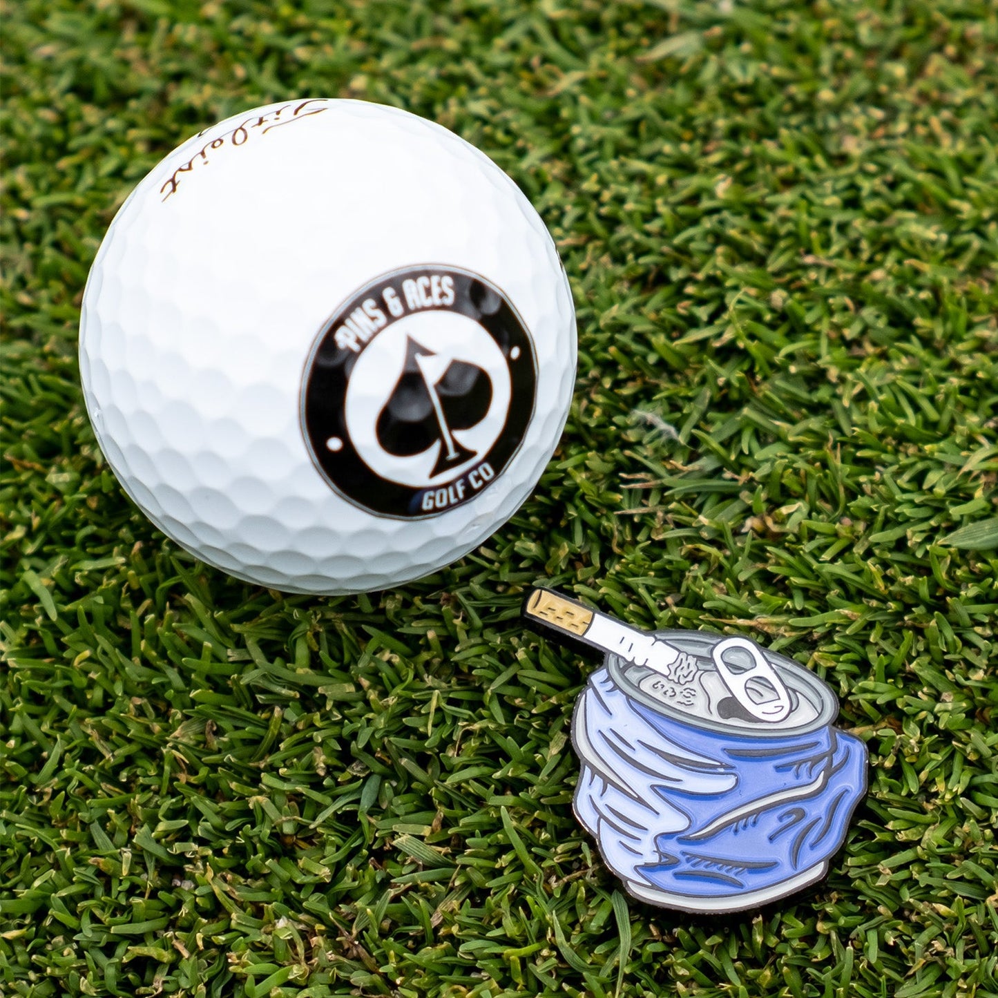 Crushed can ball marker featuring a colorful design, ideal for golf enthusiasts.