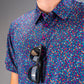 Bold golf shirt featuring a vibrant lavender floral pattern, complemented by stylish sunglasses hanging from the collar.