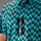 Bold wavy checkered golf polo in teal and black, featuring a classic collar and sunglasses casually draped on the front.