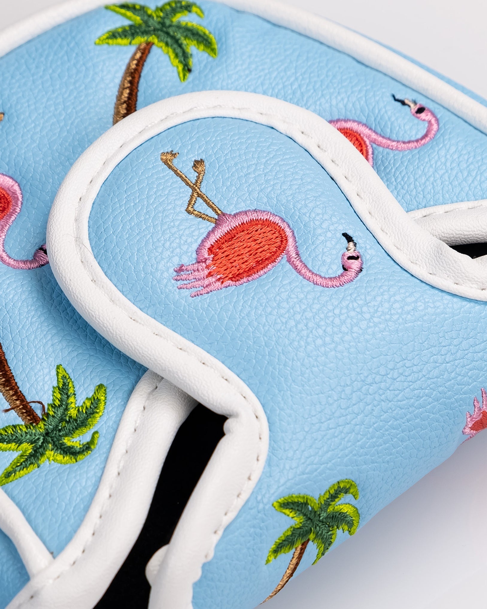 Dancing Flamingos mallet putter cover featuring vibrant pink flamingo designs on a black background.