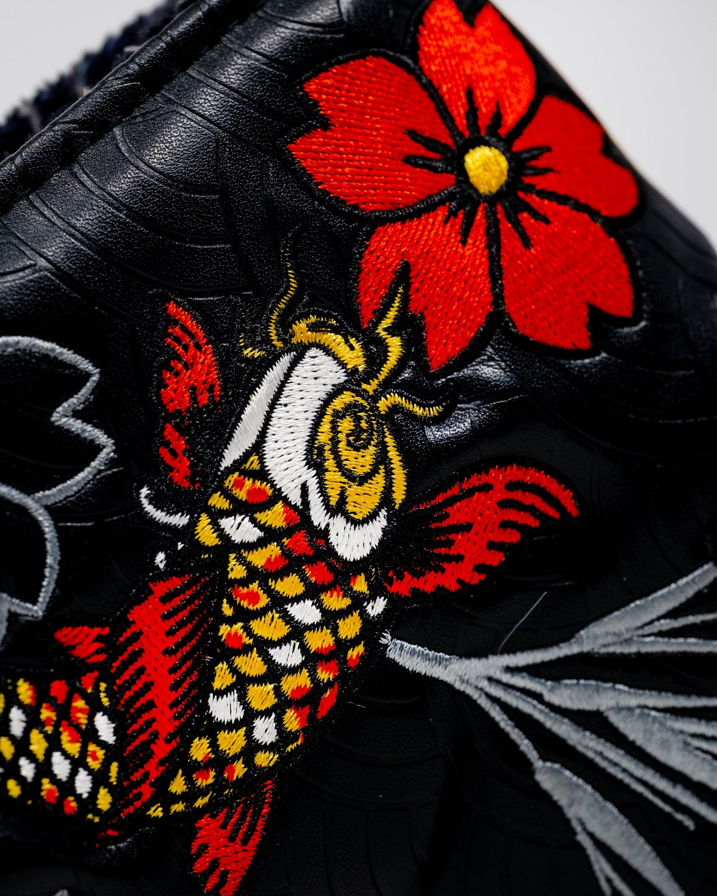 Koi Flow Blade Putter Cover featuring a vibrant fire wave design in shades of orange and blue.
