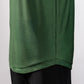 Close-up of a green Player Preferred™ Polo shirt with a forest wave pattern, paired with black pants.
