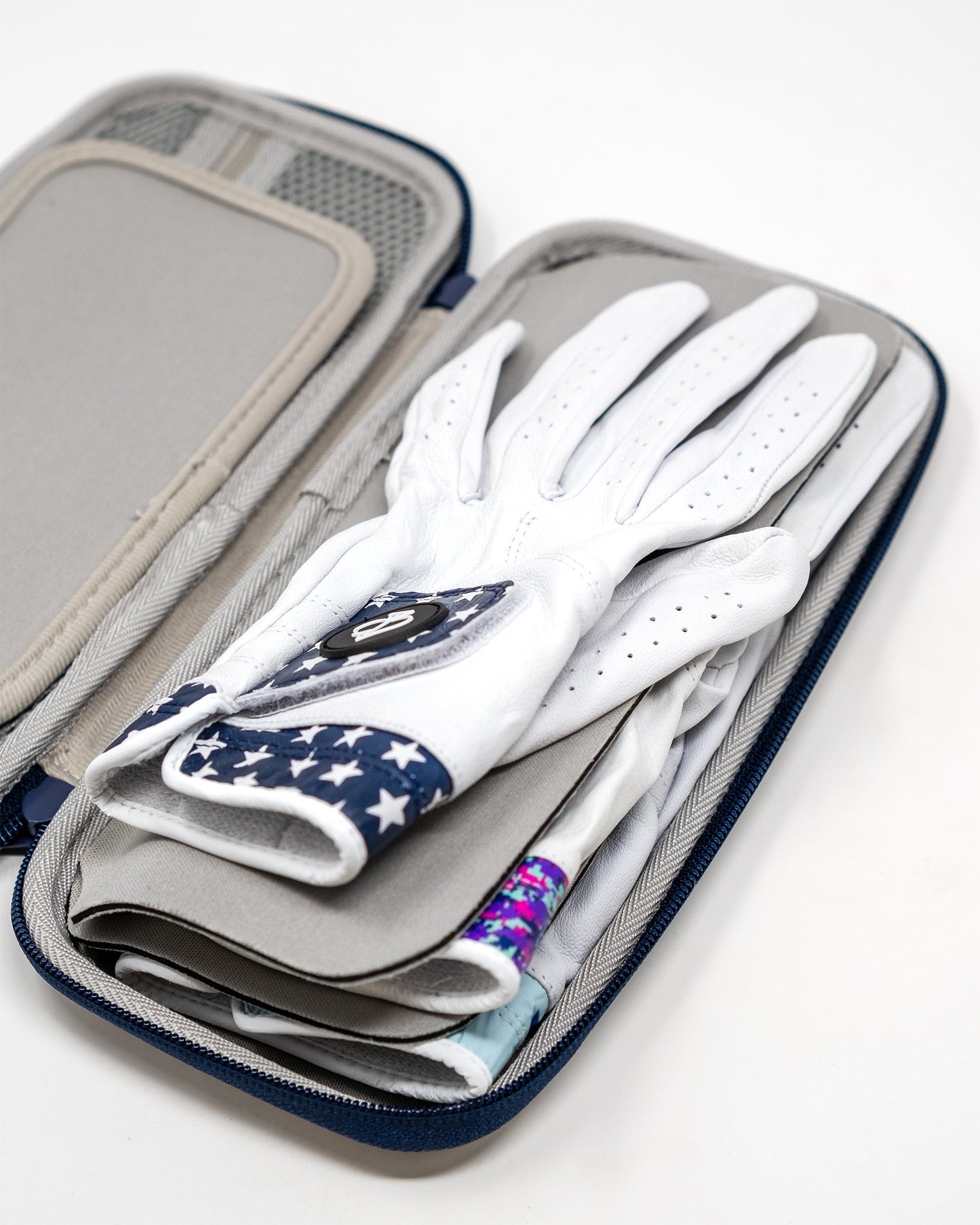 Gray glove and accessory caddie featuring multiple compartments for organized storage, ideal for golf gloves and small items.