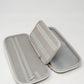 Gray glove and accessory caddie with a zippered compartment and elastic straps for organization.