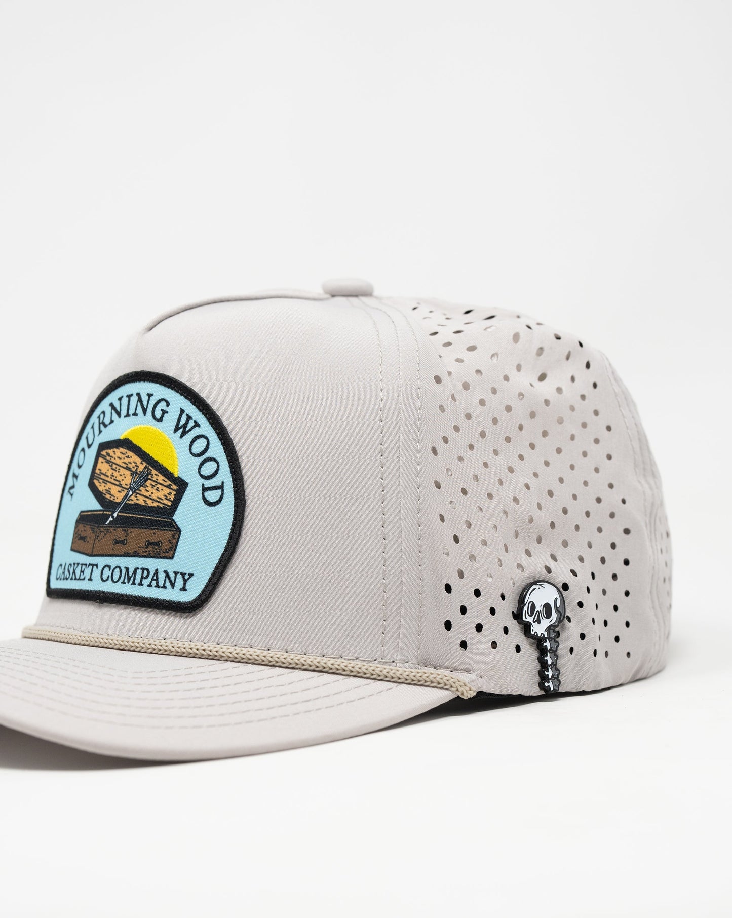 Perforated Rope Hat in Mourning Wood and Bone colors, featuring a stylish design with a rope detail at the front.