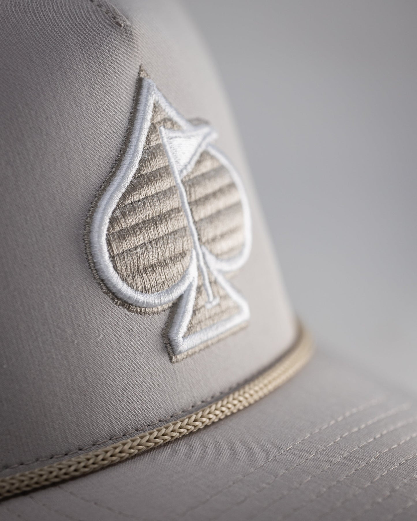 Perforated Bone Rope Hat with a stylish design and adjustable chin strap.