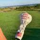 Trump Fairway Cover featuring a sleek design in rich colors, ideal for protecting golf clubs while showcasing a unique presidential theme.