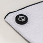 Magnetic white towel showcasing a sleek design with attachment magnets for easy hanging.