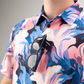 Men's Melting Floral golf shirt featuring vibrant pink and blue floral patterns, with sunglasses hanging from the collar.
