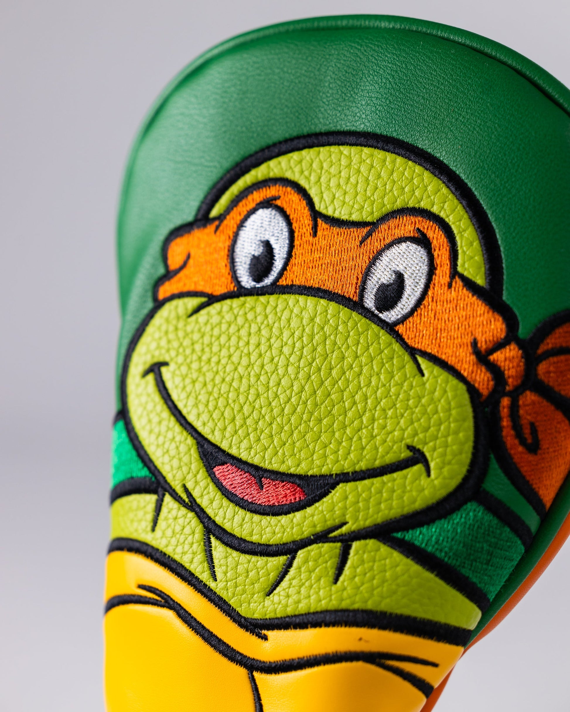 TMNT Michelangelo fairway golf club head cover featuring vibrant orange and green colors with a turtle design.