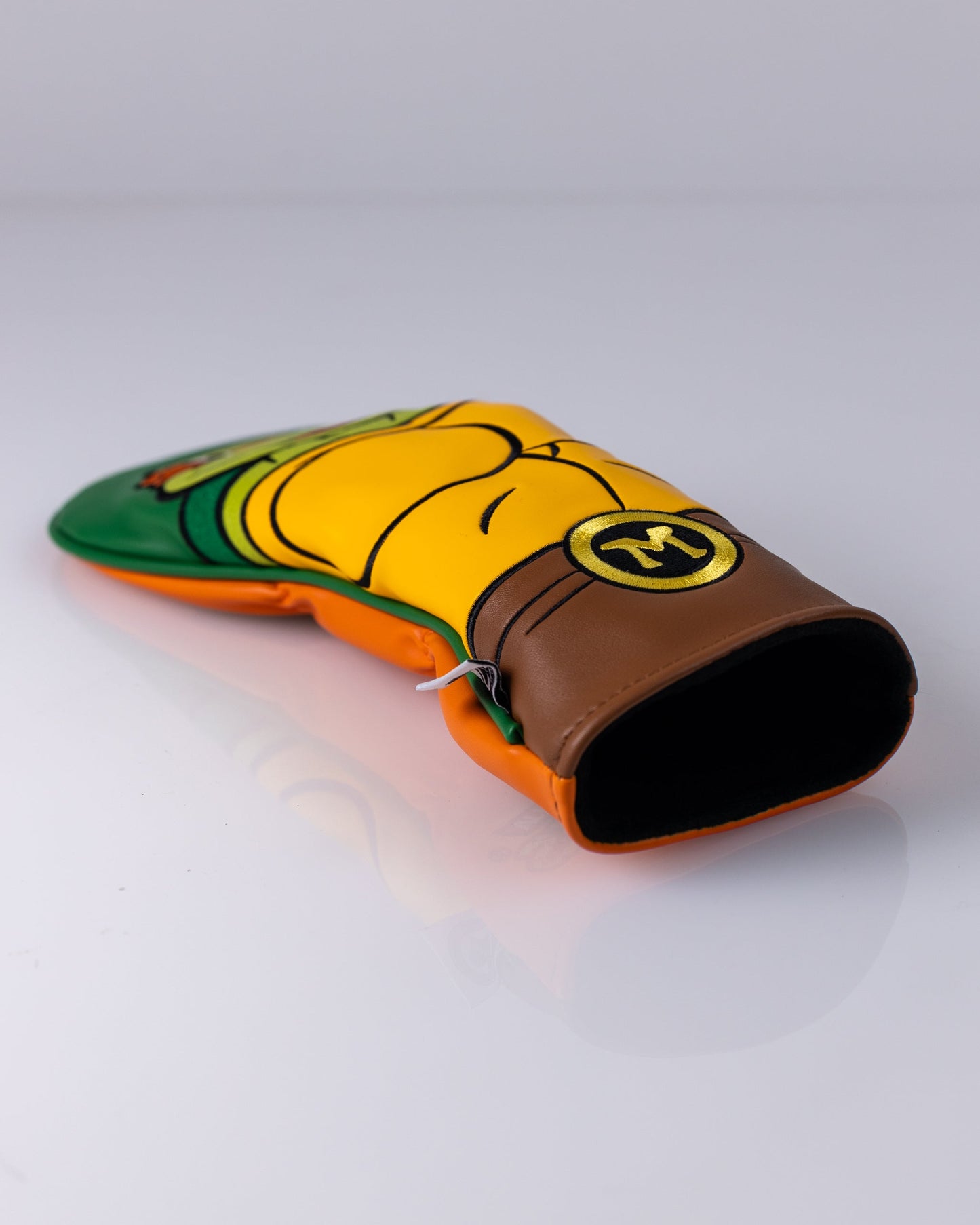 TMNT Michelangelo fairway golf club cover featuring vibrant orange and green colors, shaped like Michelangelo's head with a fun cartoon design.
