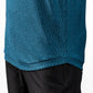 Close-up of a teal Player Preferred™ Polo shirt with a subtle, intricate pattern, paired with black pants.