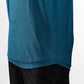 Close-up of a blue Player Preferred™ Polo shirt with a wave pattern, paired with black pants.