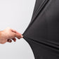 Close-up of a hand stretching a black Player Preferred™ Polo Midnight Spade fabric, showing its stretch and texture.