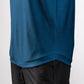Close-up of a navy Player Preferred™ Polo with Spade Fade design, worn over black pants, showing fabric texture and stitching.