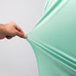 Close-up of a hand stretching a mint green Player Preferred™ Polo with spearmint stripes fabric, showing its smooth, stretchy material.