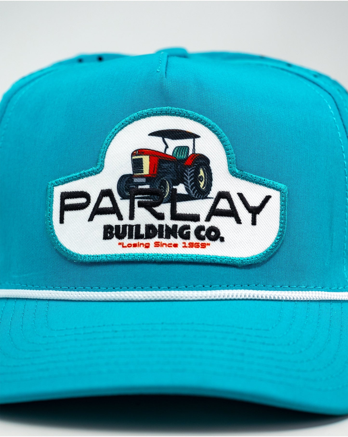 Perforated baby blue rope hat by Parlay Building Co. with a stylish patch logo.