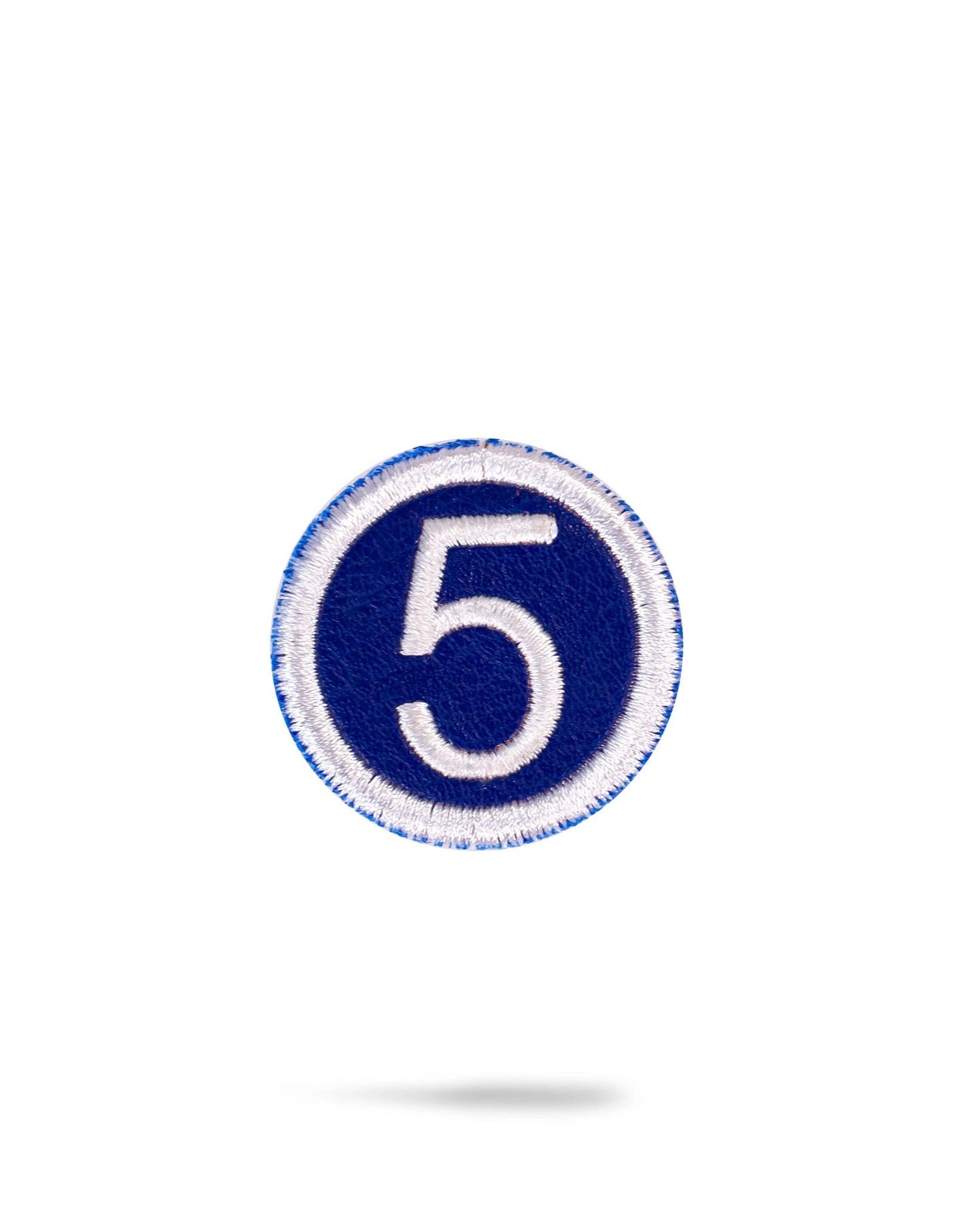 Blue headcover patch featuring a stylish design.