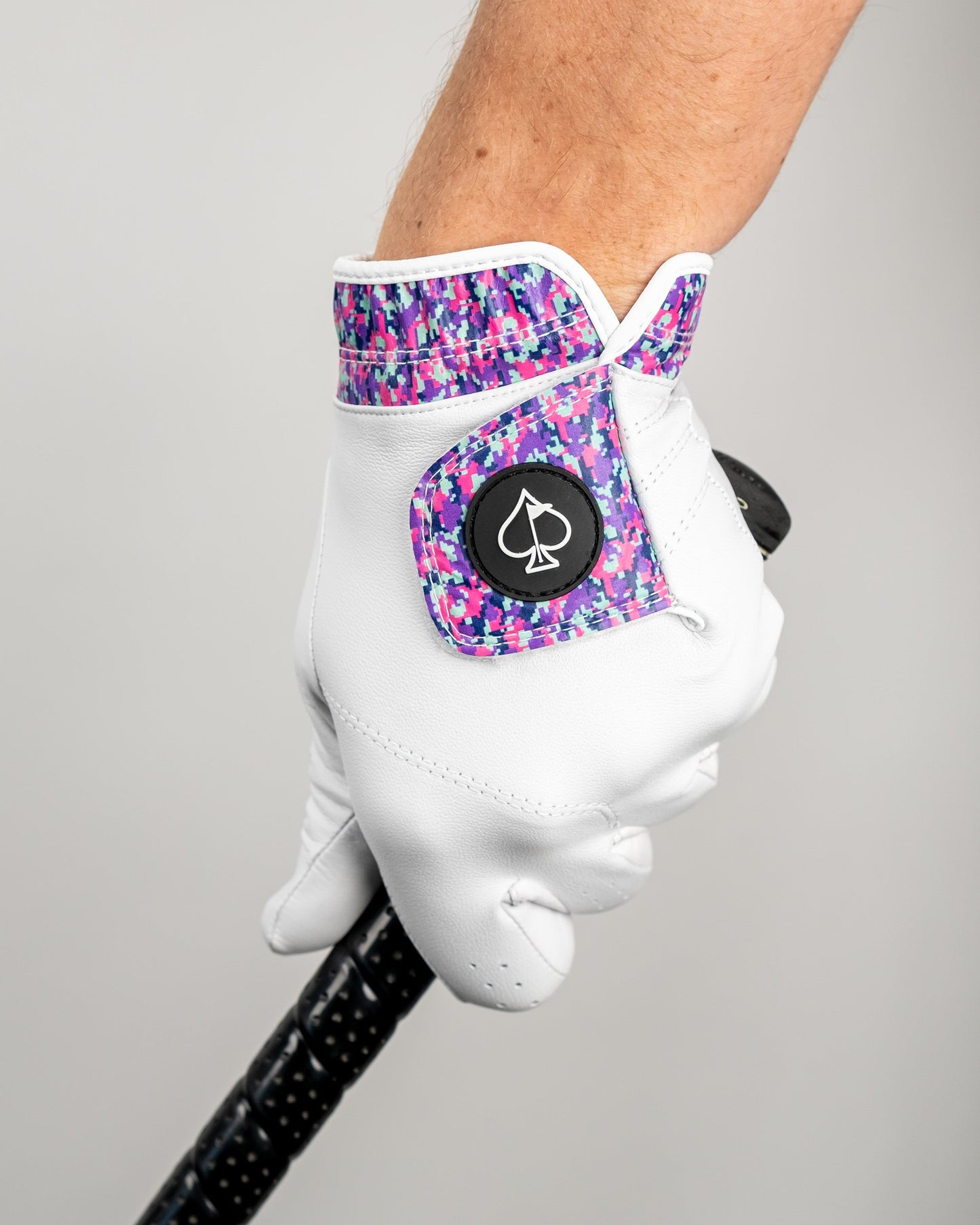 Premium Tour Glove in vivid camouflage design, showcasing a close-up of the grip detail.