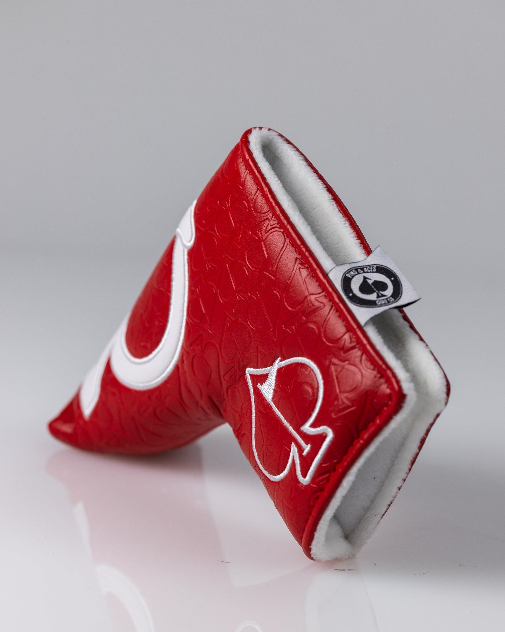 Bold red golf headcover with white embroidered logo and soft white fleece lining for standout style.