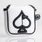 White golf headcover with black spade and flag embroidery, textured background, and "Pins & Aces" logo tag.