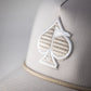 Perforated rope hat in bone color featuring a textured spade logo and a stylish rope detail along the brim.