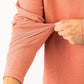 Terracotta waffle knit pullover showcasing a close-up of the textured fabric and sleeve detail. Ideal for stylish golfers.