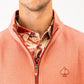 Terracotta waffle knit pullover with a half-zip collar, featuring a logo on the chest and a patterned shirt underneath.