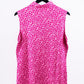 Pink sleeveless golf polo with a bold floral pattern, perfect for golfers who want to stand out on the course.