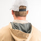 Men's performance golf hoodie in sand color, featuring a lightweight design and stylish layered look with a patterned collar.