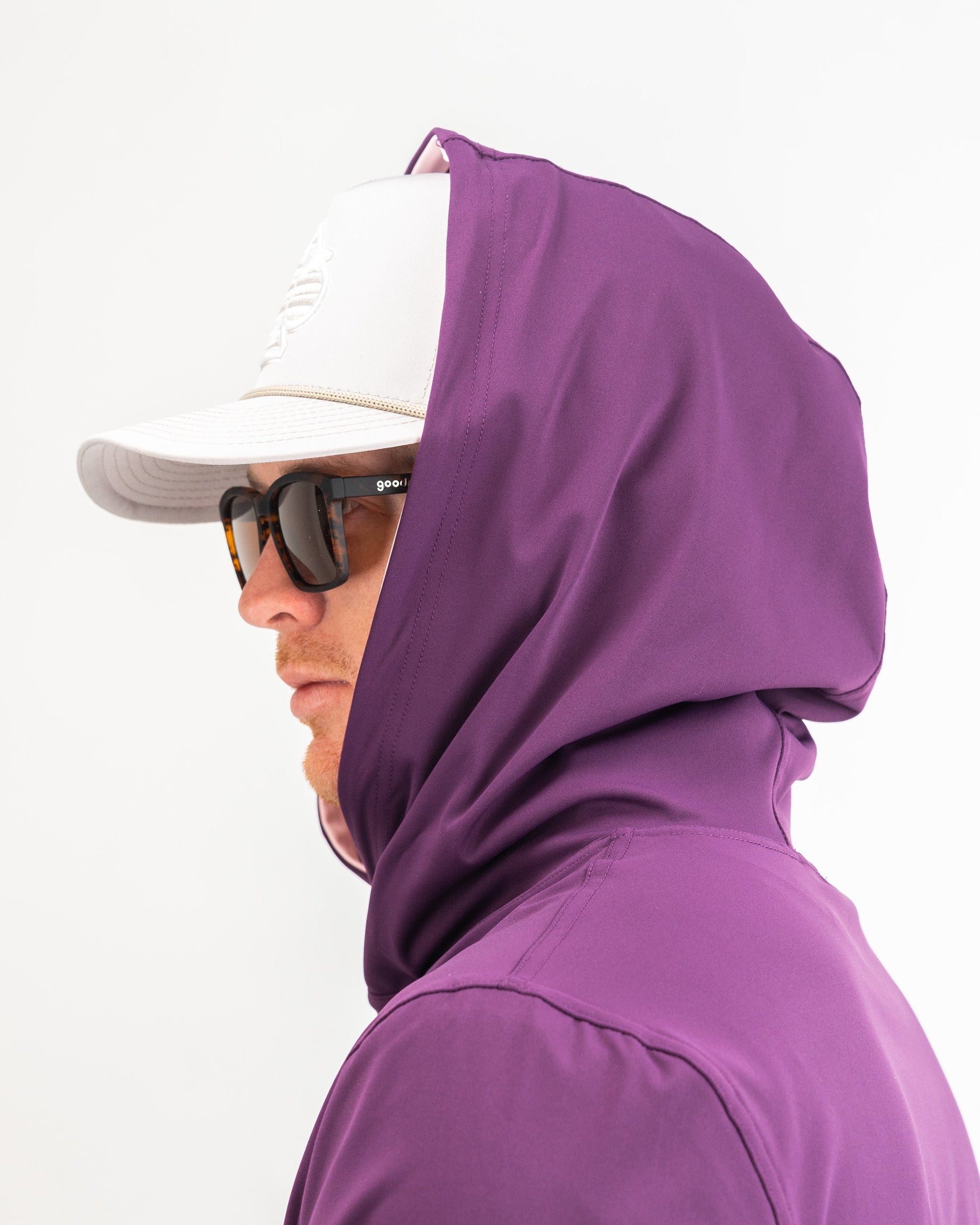 Performance golf hoodie in houndstooth raspberry, featuring a sleek design and a comfortable fit for stylish golfers.