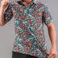 Bold teal golf polo featuring a vibrant tiger and floral pattern, perfect for golfers looking to make a statement on the course.