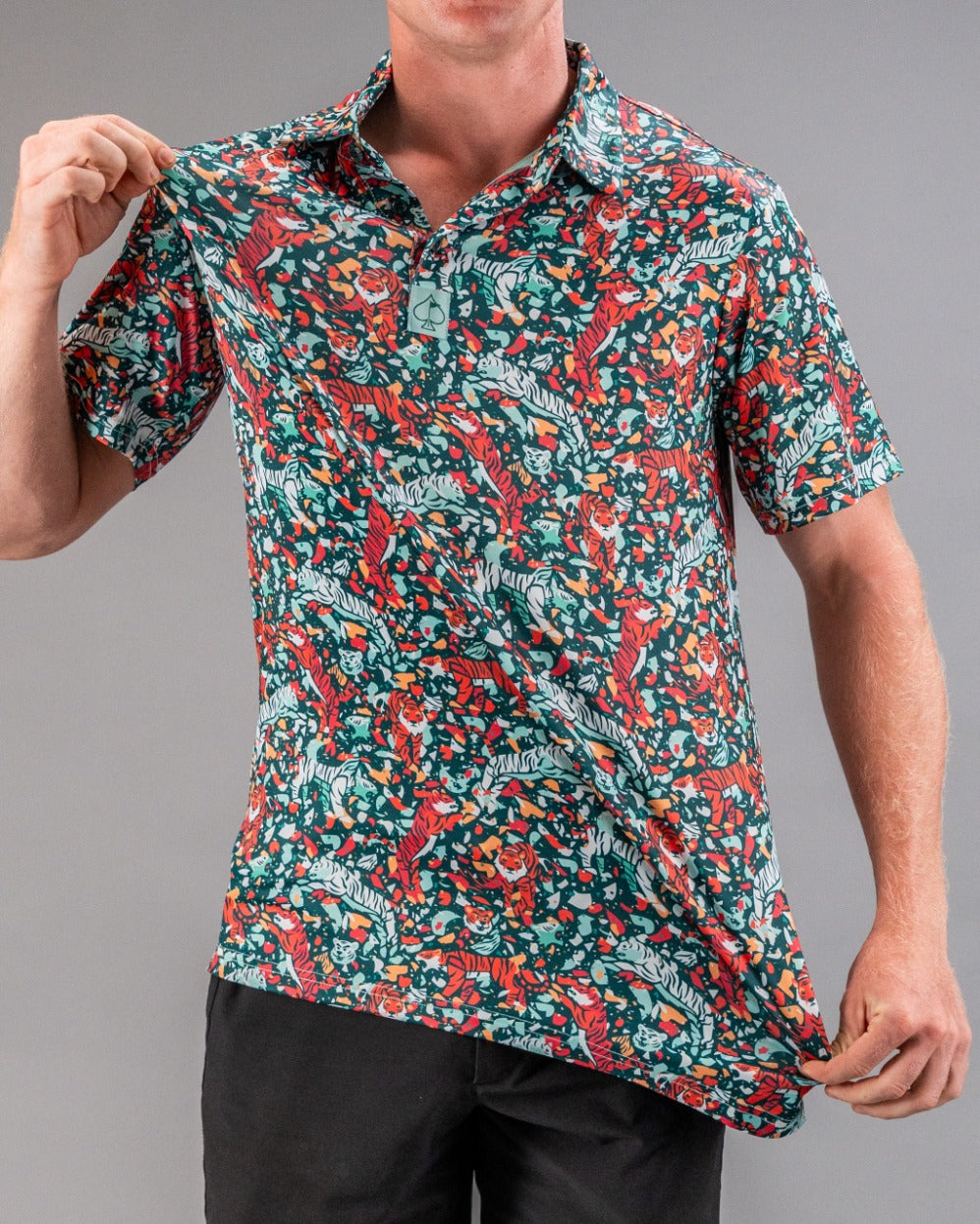 Bold teal golf polo featuring a vibrant tiger and floral pattern, perfect for golfers looking to make a statement on the course.