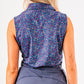 Women's sleeveless lavender floral golf shirt featuring a vibrant pattern, perfect for stylish performance on the course.