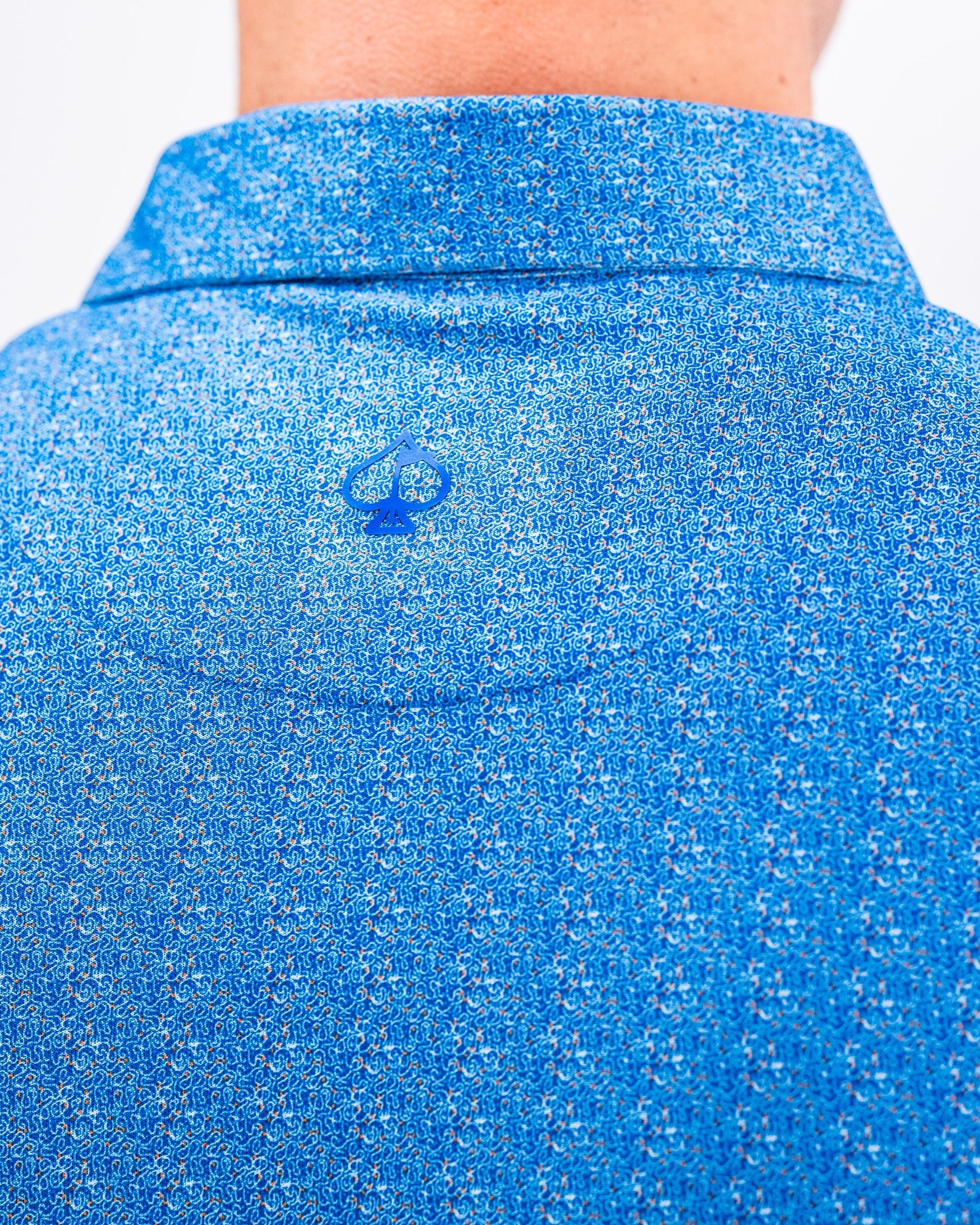 Player Preferred™ Polo in Cosmic Swirl design featuring a colorful, abstract pattern.