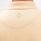 Close-up of the back of a beige Player Preferred™ Pullover with a small embroidered spade logo near the collar.