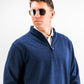 Man wearing a navy heathered Player Preferred™ Pullover with sunglasses, facing slightly to the side against a plain background.