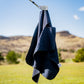Black magnetic towel hanging on a hook, showcasing its sleek design and fabric texture.
